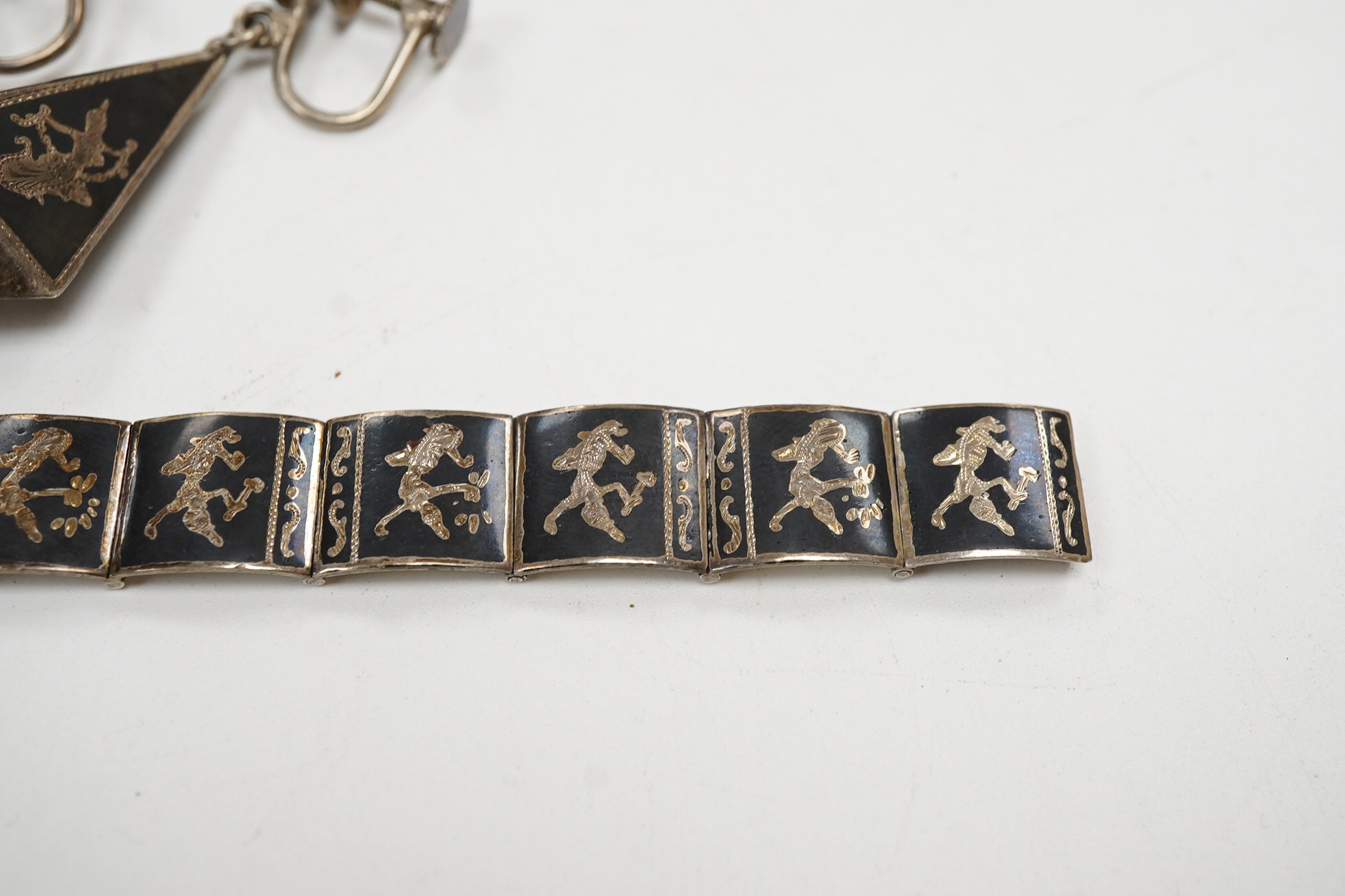 A Thai sterling and niello bracelet, 16.2cm, together with a pair of similar earrings.